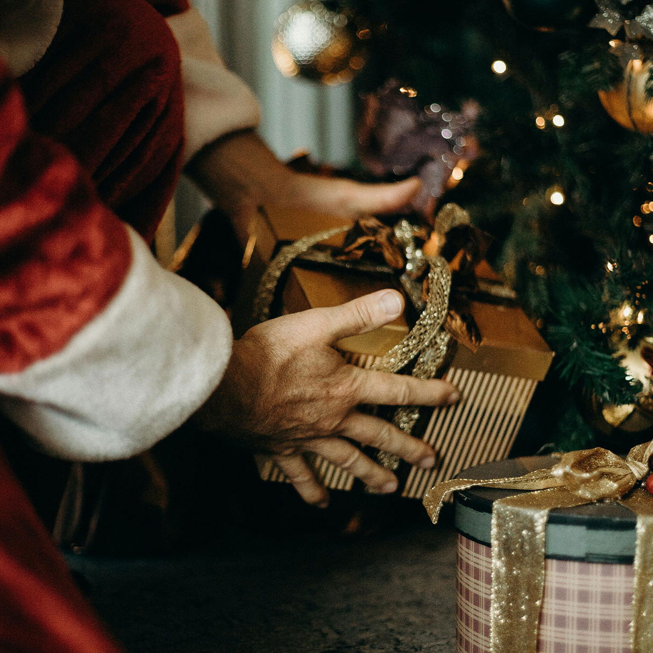 A person opening a Christmas gift