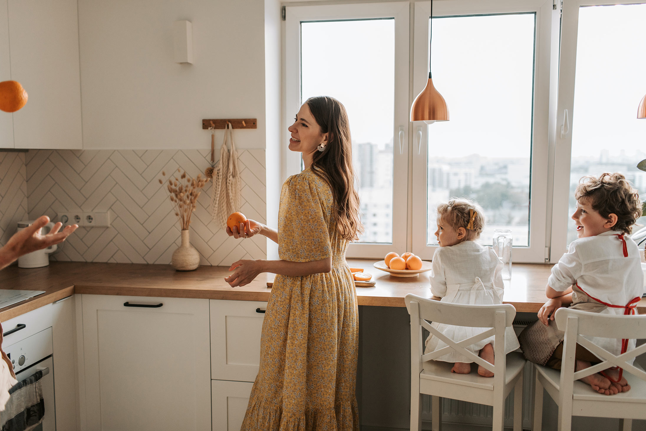 A mother and children being happy in a kitchen in celebration of Mother's Day