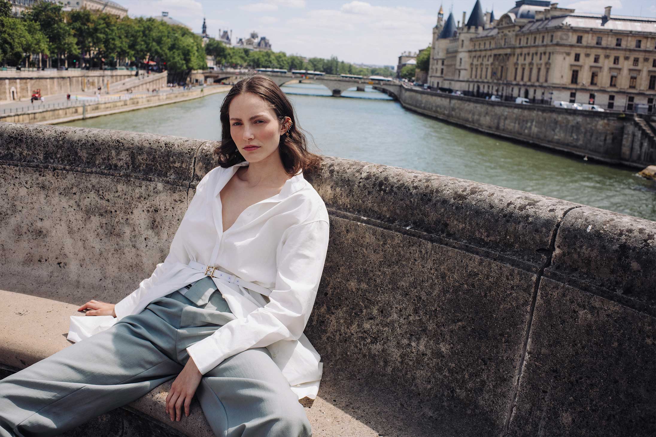 A model poses on the streets of Paris wearing Fendi