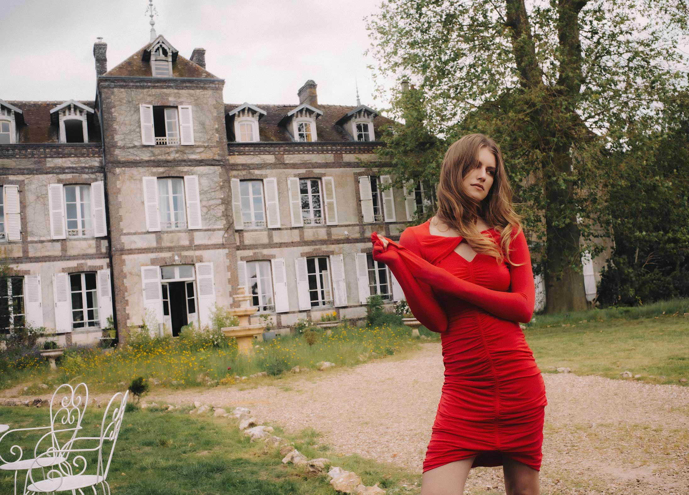 A model poses in front of a chateau wearing Isabel Marant