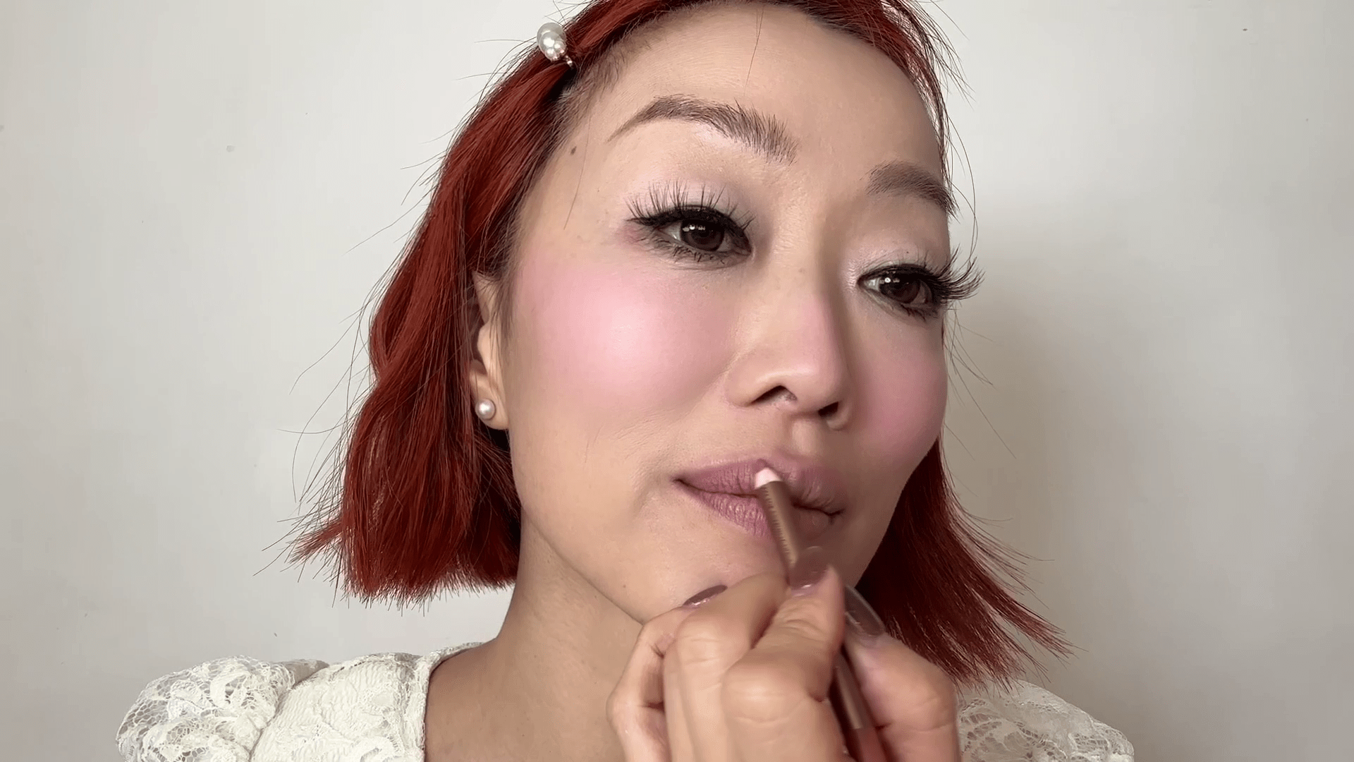 A makeup artist creating a Valentine's Day lip look